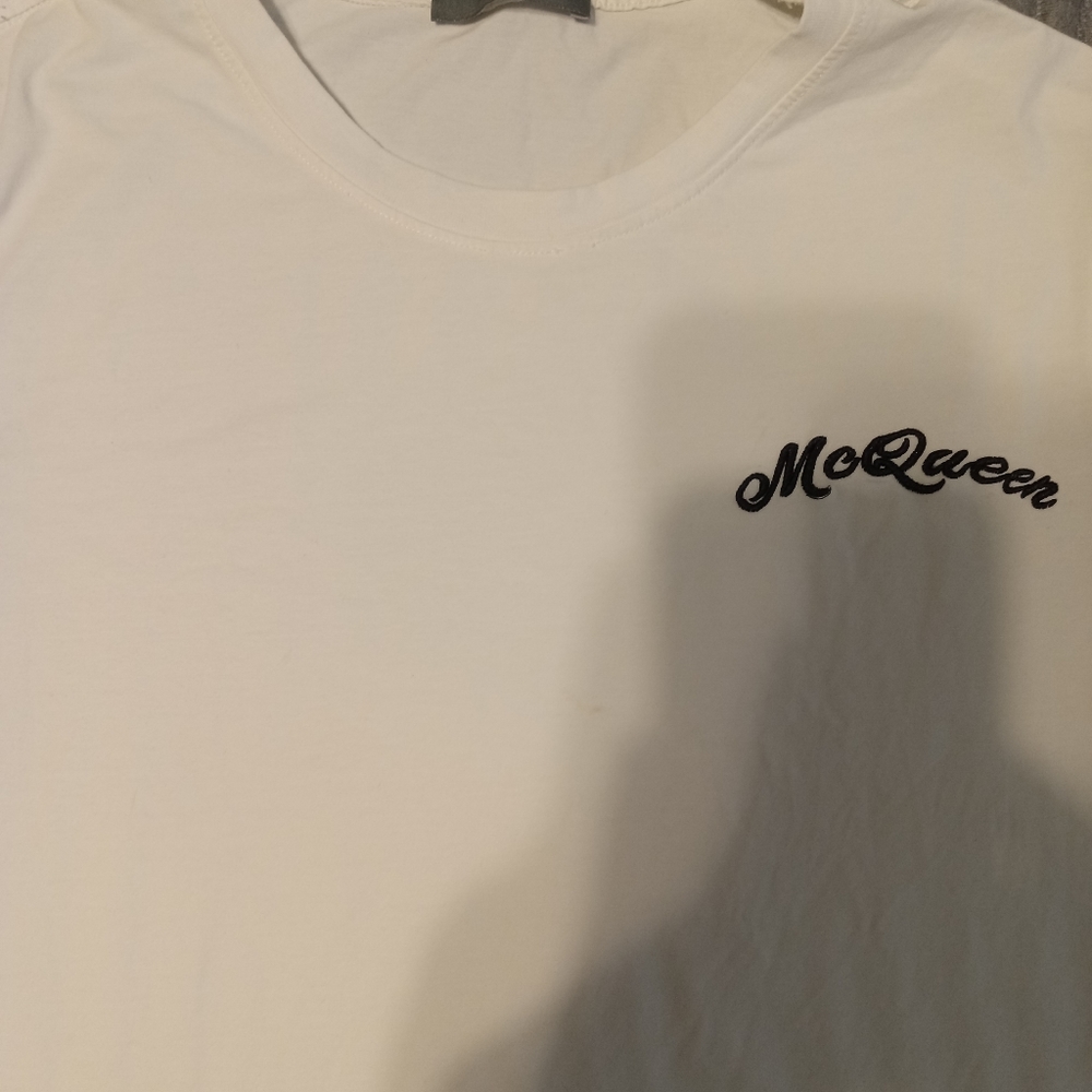 Alexander McQueen T Shirt All white with the Logo on front and a small hole